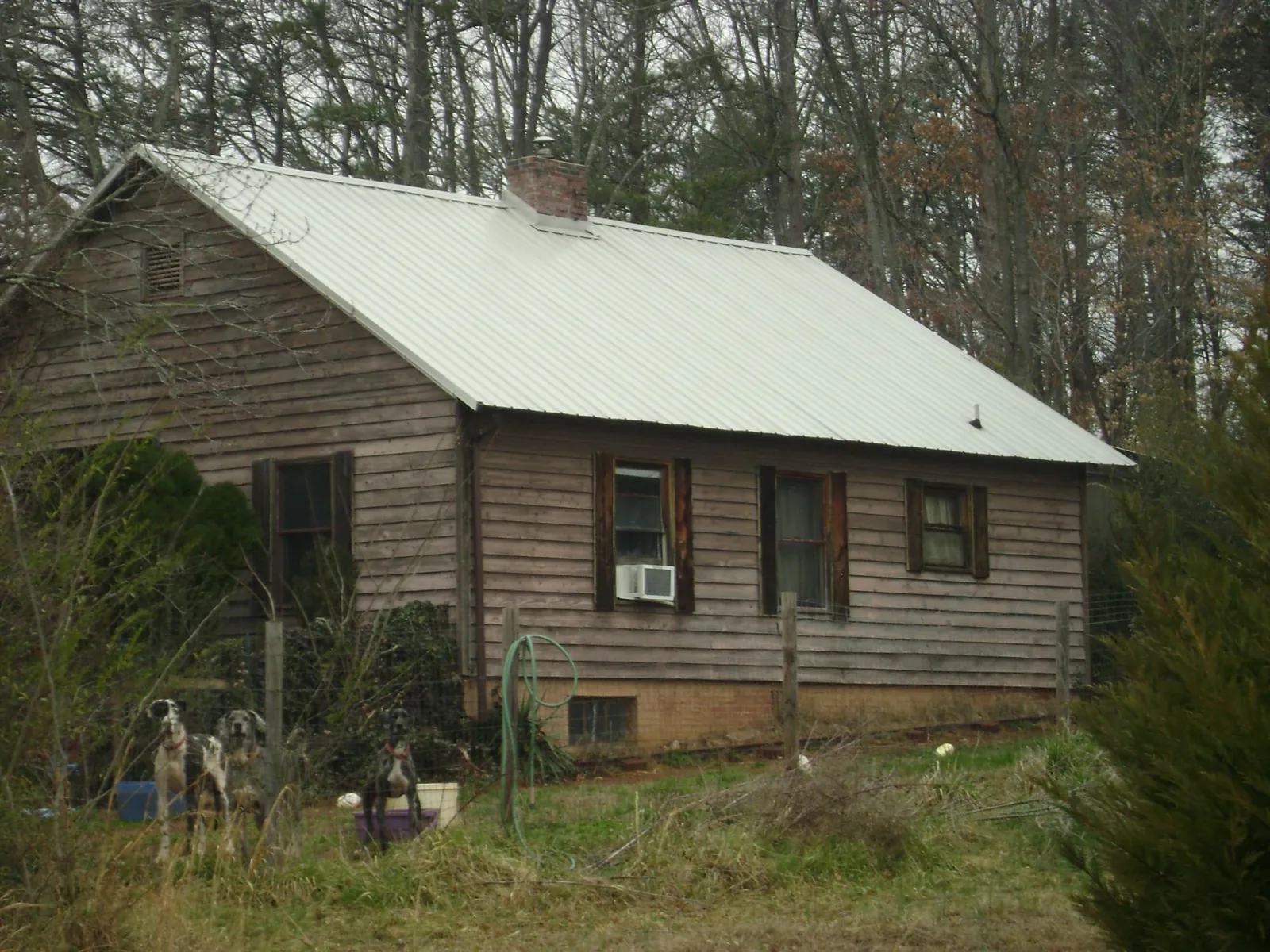 White metal roof on an old wood sided farmhouse, from a Metal Roof Installation job in Whitinsville